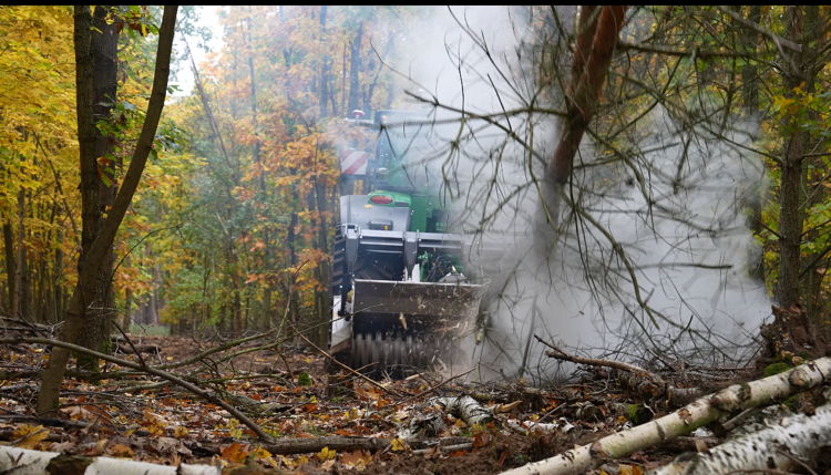 Photo of the vehicle from behind during terrain maintenance in the forest