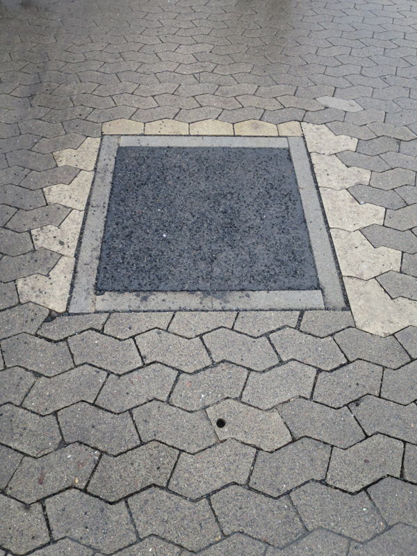 Photo of an induction coil in the road surface with a hole for the RFID tag (transponder)
